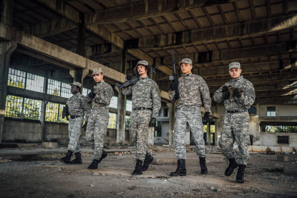 istock Military team patrolling through ruined building 1352942066
