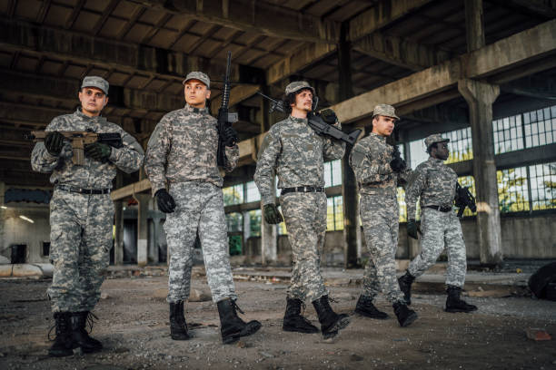 istock Military team patrolling through ruined building 1352943170