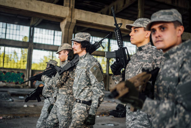 istock Military team patrolling through ruined building 1352944237