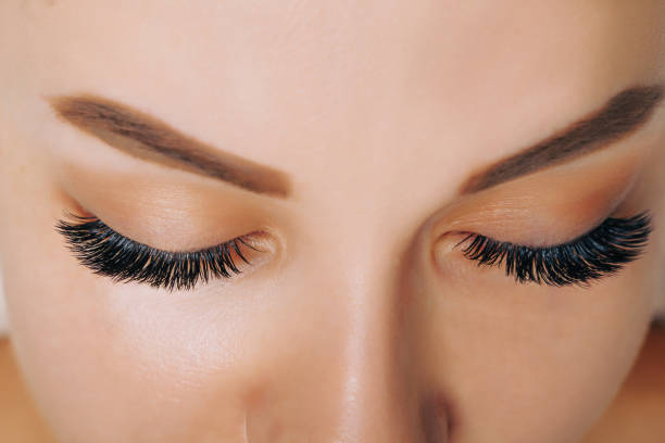 istock Eyelash Extension Procedure. Woman Eye with Long Eyelashes. Close up, selective focus 1352945394