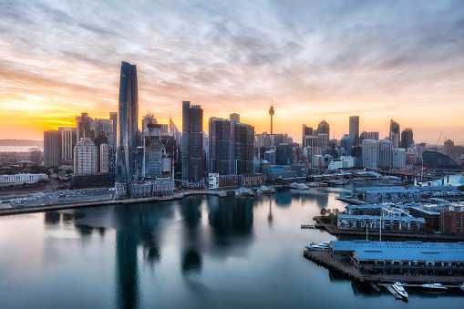 Aerial sunrise over city of Sydney skyline from Darling Harbour and Pyrmont to Barangaroo high-rise towers.
