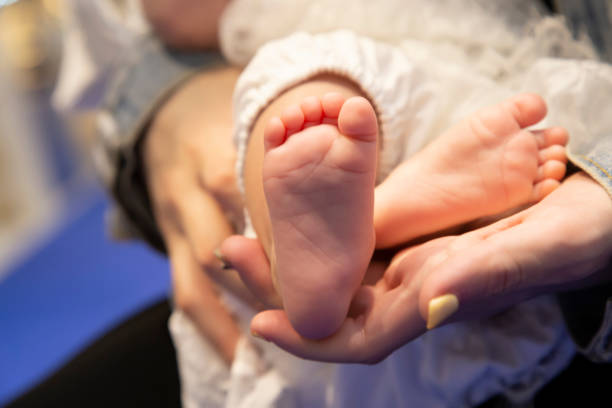 istock Akachan's right foot and mom's hand 1352946569