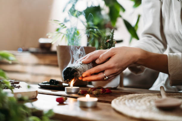 istock Hands burning white sage for ancient spiritual ritual 1352947132