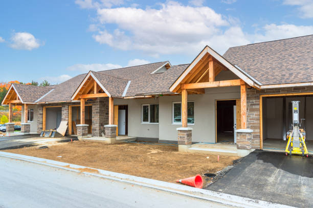 Row houses in construction in a suburban housing development Houses in construction in a housing development on a clear autumn day huntsville ontario stock pictures, royalty-free photos & images