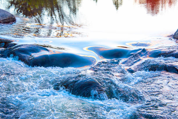 Rapids with reflection from the setting sun, on the AuSable River-Grayling Michigan