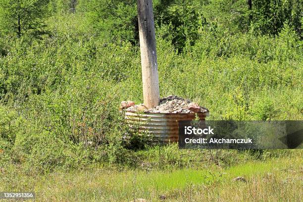 A Powerpole Stabalized And Anchored By Rocks Stock Photo - Download Image Now - Animal Pouch, Canada, Color Image