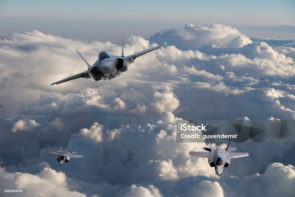 F-35 Fighter Jets flying over clouds Fighter Plane Stock Photo