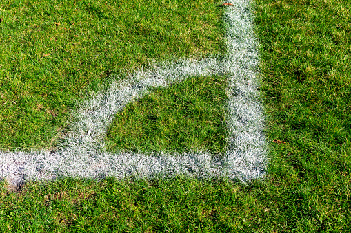 Soccer field corner painted on green grass