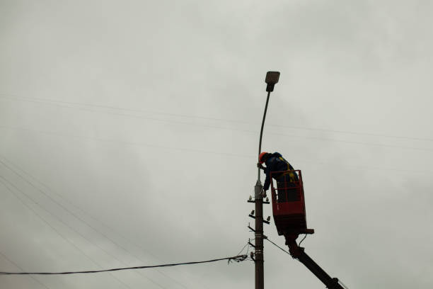 istock The high-riser changes the wires. Work at height. Repair of a pole with a lamp. 1352958805