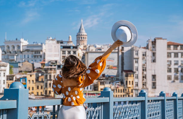 istock Young traveler woman posing on Galata Bridge,  while exploring istanbul 1352958859