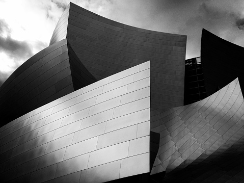 Low-angle black and white shot of the distinctive Walk Disney Concert Hall in Los Angeles
