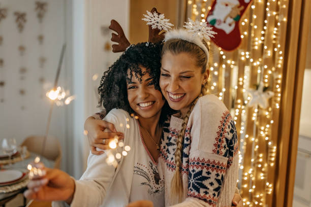 istock Two young woman celebrating New Year with fireworks 1352965473