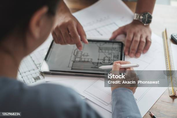 Architect Or Engineer Team Designer Discussing Detail Drawing On Digital Tablet Stock Photo - Download Image Now