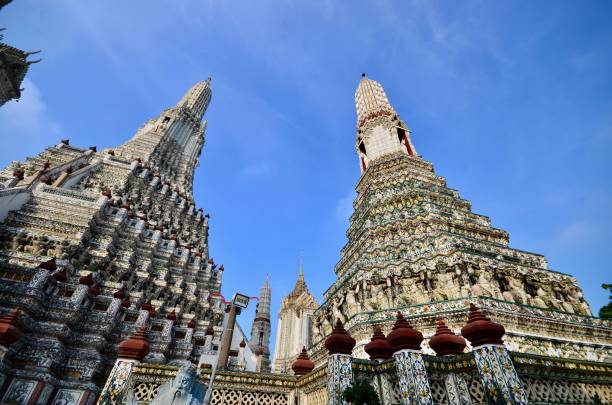 Temple of Dawn Wat Arun is a temple venerated by all Thais. Otherwise known as the Temple of the Dawn, this sacred site sits along the mighty Chao Phraya River and is one of the most stunning religious structures in the world. wat arun stock pictures, royalty-free photos & images