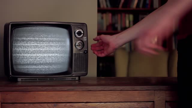 Man hitting an Old TV with Green Screen. Close-Up. 4K Resolution.