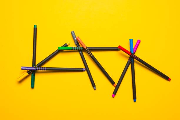 istock Color markers on yellow background 1352972541