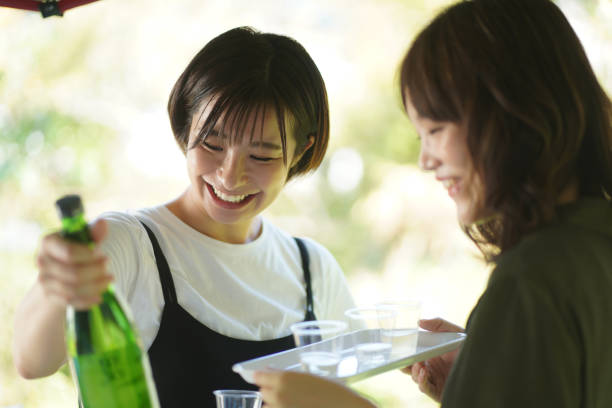 Female tasting sake Female tasting sake saki photos stock pictures, royalty-free photos & images