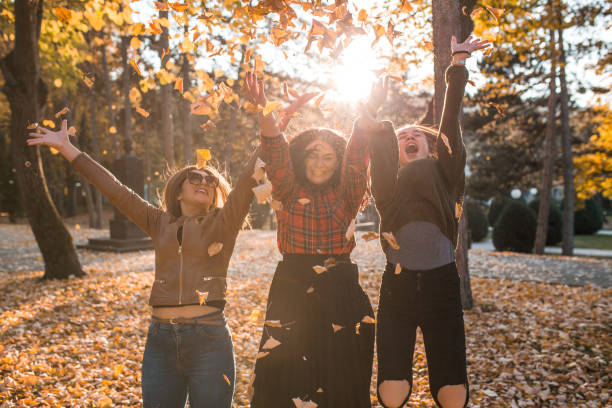 istock Three women enjoying in the park and jumping 1352975224