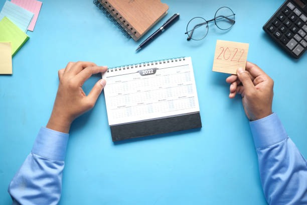 istock deadline concept with hand marking date on calendar top view 1352976844