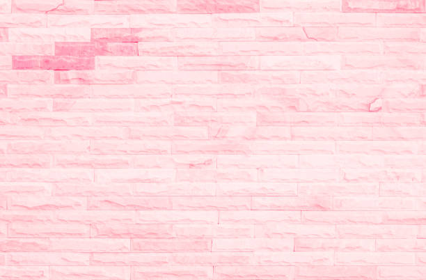 istock Empty Pink brick wall texture background in the bedroom at lovely. Brickwork stonework interior, rock old clean concrete grid uneven abstract weathered brick design, horizontal architecture wallpaper. 1352978640