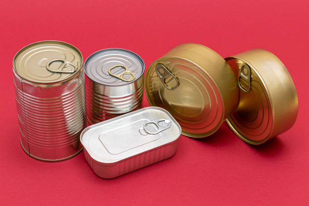 istock Unopened Tin Cans with Blank Edges on Red Background 1352987769