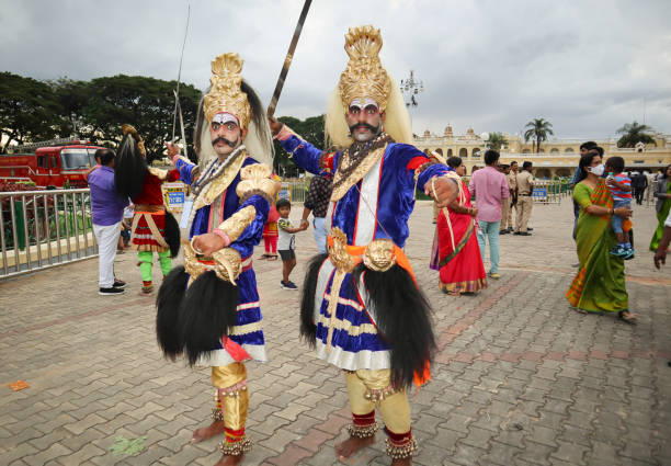 Folk Artists dressed in colorful period costume of the Lord Shiva God pose for a candid photograph during Dasara festival in Mysore, India. Folk Artists dressed in colorful period costume of the Lord Shiva God pose for a candid photograph during Dasara festival in Mysore, India. mysore stock pictures, royalty-free photos & images