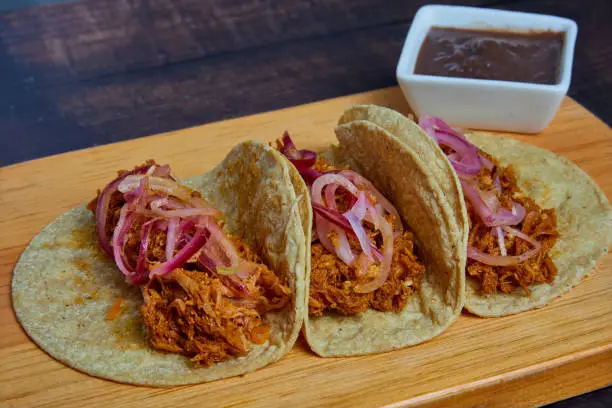 Photo of Tacos de Cochinita Pibil, traditional Mexican food. Typical cuisine of the Yucatan region in southern Mexico.