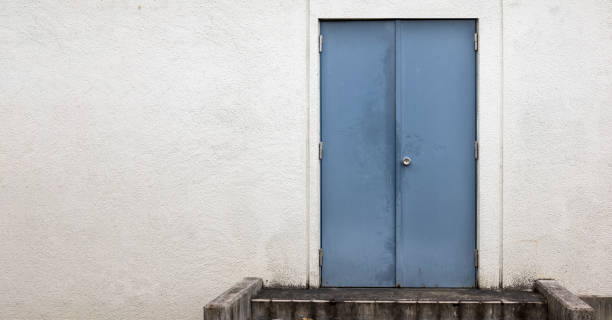 istock Background image of white wall and iron door 1352994423