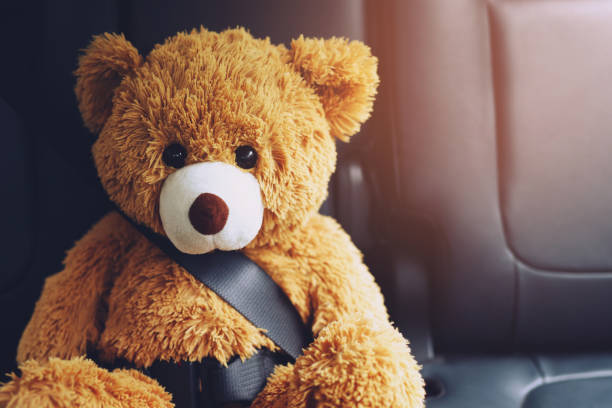 istock Brown teddy bear wearing car seat belt 1352996065