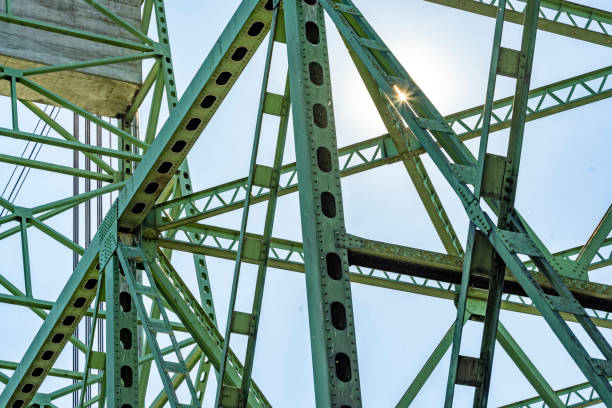 istock Sun glare on the intertwining openwork riveted trusses of a metal lifting bridge with a counterweight 1353000955