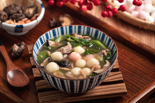 Red and white tangyuan with savory soup.