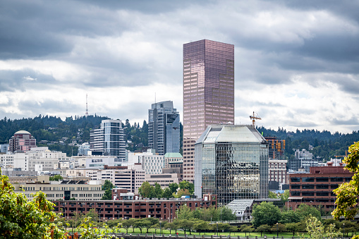 Down town landscape of modern Portland with high-rise glass and metal skyscrapers with offices and apartment buildings of various architecture and heights against the background of a stormy sky