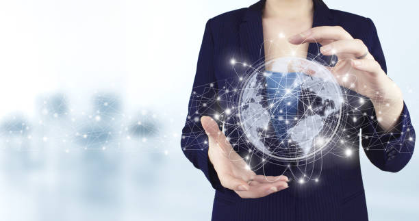 istock Abstract world network connection, internet and global connection concept. Two hand holding virtual holographic world, earth, map, globe icon with light blurred background. Global technologies 1353001695