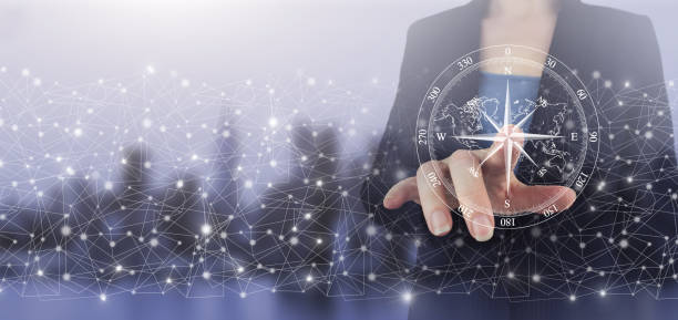 istock Navigation concept. Map and innovation concept. Hand touch digital screen hologram compass sign on city light blurred background. The compass navigate for business 1353001700