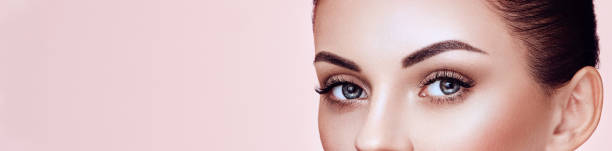 Beautiful woman with long false eyelashes Beautiful Young Woman with Clean Fresh Skin. Perfect Makeup. Eyelashes. Eyelash Extensions. Cosmetology, Beauty and Spa. Model Smiling false lashes stock pictures, royalty-free photos & images