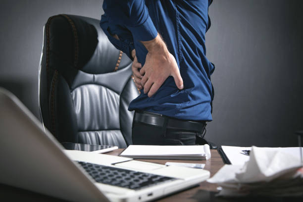 istock Caucasian businessman suffering from back pain in office. 1353005415