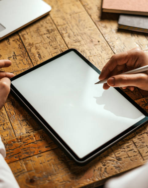 istock Male hands drawing on digital tablet with electronic pen. Freelancer designer working remotely. Close-up photo. Mock-up. Blank white screen 1353005454
