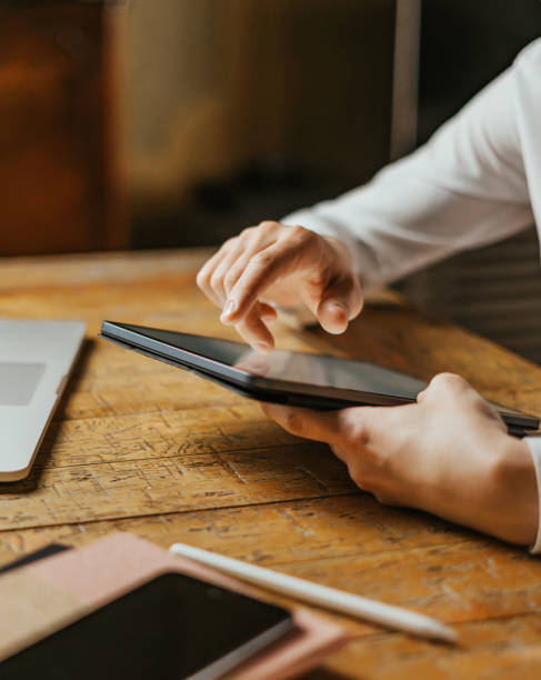 istock Male hands tapping on digital tablet screen. Close-up photo 1353005472