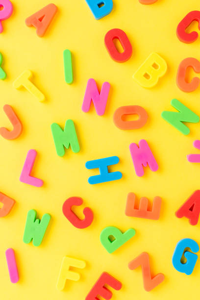 istock School background with colourful letters on yellow table. Funny pattern 1353010072