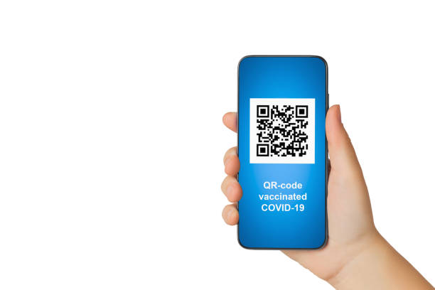 A beautiful hand of a girl holds a smartphone on the screen of which there is a QR-code about vaccination against covid-19. Isolated on white background. The image has copy space for text. A beautiful hand of a girl holds a smartphone on the screen of which there is a QR-code about vaccination against covid-19. Isolated on white background. The image has copy space for text. qr code photos stock pictures, royalty-free photos & images