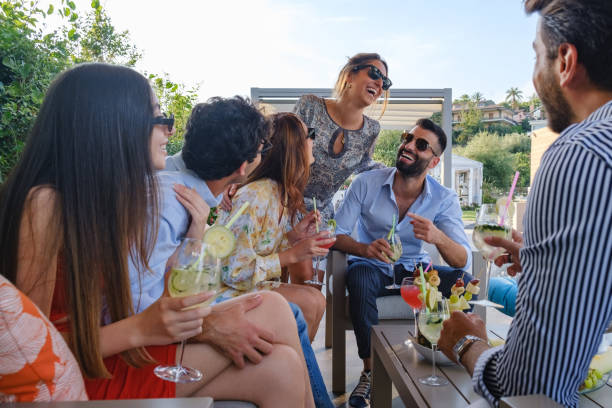 istock Group of friends relaxing and laughing during get together 1353011683