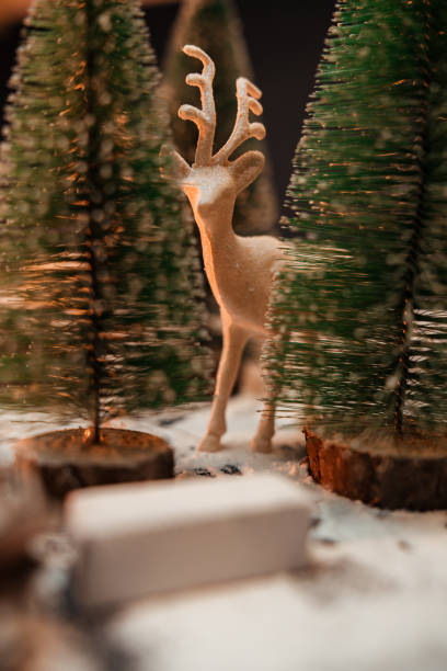 istock Reindeer figurine surrounded with Christmas tree and snow 1353012023