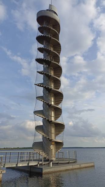 istock Spiral tower over lake water 1353016032