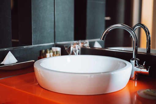 Modern round bathroom sink in the hotel