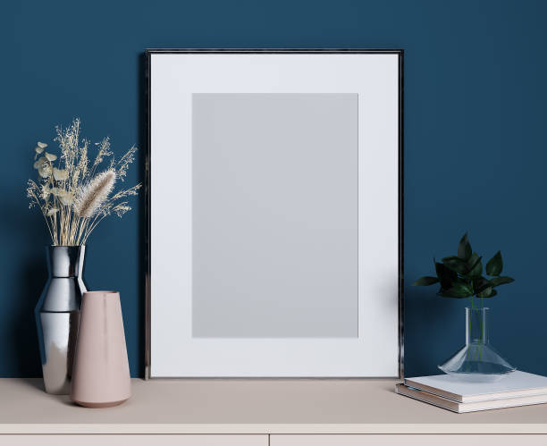 istock Stylish decorative set with silver frame for mockup, blue wall, pink shelf and plants, 3d rendering 1353020454