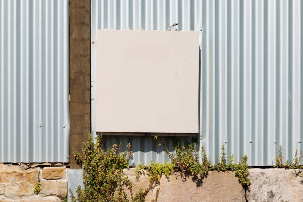istock Metal electrical box on a fence 1353022663