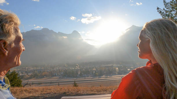 istock Couple enjoy sunset from mountain ridge 1353024616