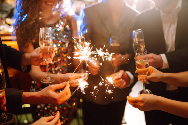 istock Sparkling sparklers in the hands. Playing firework to celebrate winter holidays with friends at the party. 1353024708