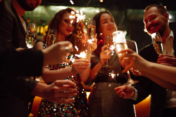 istock Sparkling sparklers in the hands. Playing firework to celebrate winter holidays with friends at the party. 1353024768