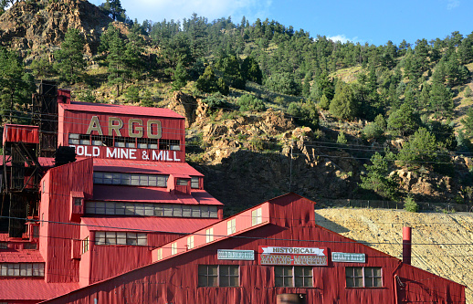 Idaho Springs, Clear Creek County, Colorado, USA: the historic Argo Gold Mine and Mill, built between Clear Creek and the mountains, the red corrugated iron building hosts a small mining museum.